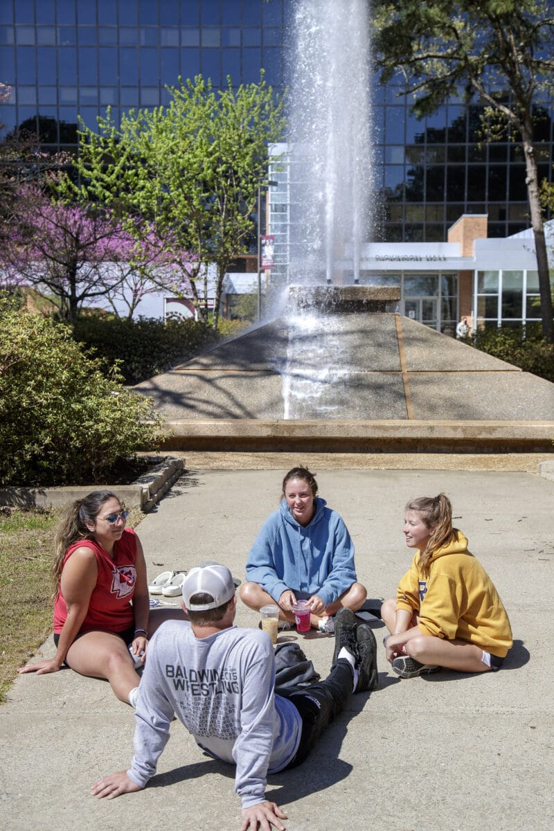 Students and visitors walking and socializing on Trojan Way.